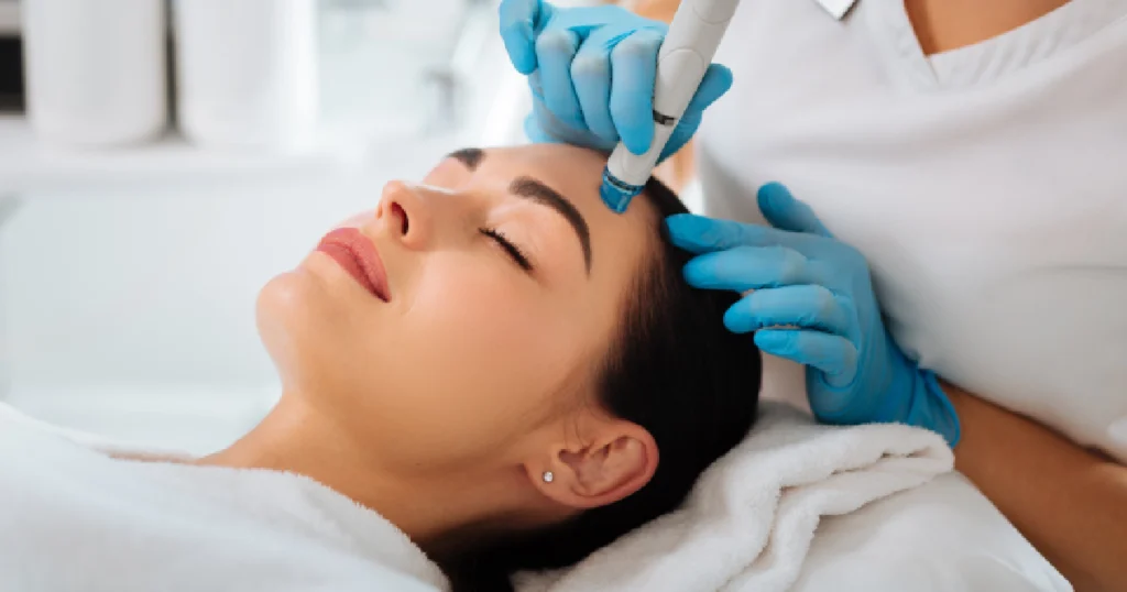 Current image: Women receiving skinpen microneedling treatment in Houston